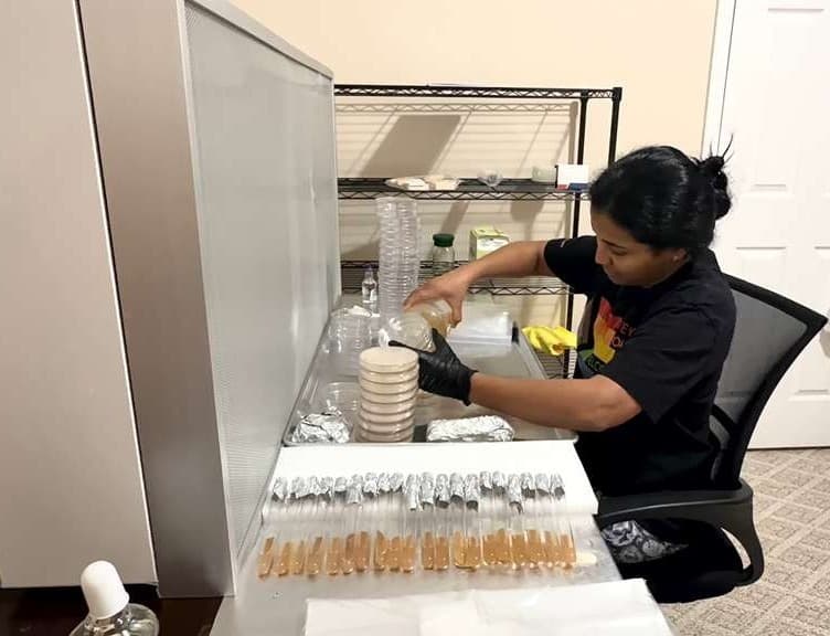 Dr. Anna Thomas pouring cultures at a still-air workspace